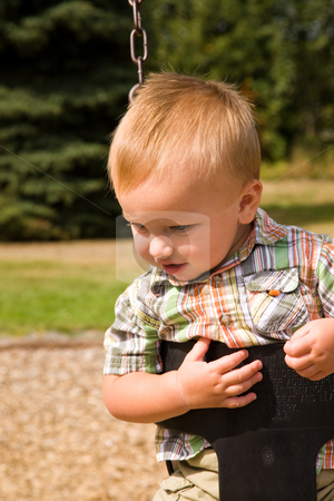 To use this stock image in your creative project, please select the size you need over to the right and click the "Add to Cart" button.
Your downloaded image will come with the Cutcaster watermark removed so don’t worry about the watermark you see on this page. Cute Baby Boy stock photo, A portrait of a cute one year old baby boy on a swing. by Travis Manley