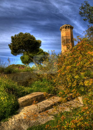 To use this stock image in your creative project, please select the size you need over to the right and click the "Add to Cart" button.
Your downloaded image will come with the Cutcaster watermark removed so don’t worry about the watermark you see on this page. Malta Watchtower Rising from the Bush stock photo, This is a portrait view of a trees beside a watchtower in Valetta, Malta. There are yellow leaves on the branches and stone steps beside the bushes. by Stephen Kiernan