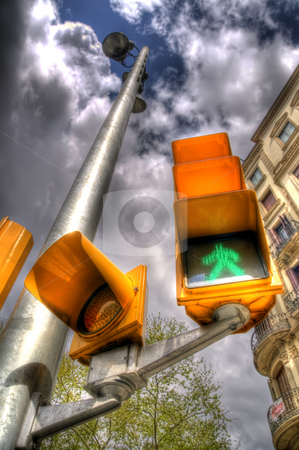 To use this stock image in your creative project, please select the size you need over to the right and click the "Add to Cart" button.
Your downloaded image will come with the Cutcaster watermark removed so don’t worry about the watermark you see on this page. Traffic Lights In Barcelona stock photo, This is a portrait shot of a set of traffic lights in Barlecona near La Rambla. The traffic pole is seen to extend into the clouds due to the unusal perspective and manner in which the image is composed. by Stephen Kiernan
