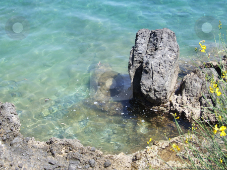 To use this stock image in your creative project, please select the size you need over to the right and click the "Add to Cart" button.
Your downloaded image will come with the Cutcaster watermark removed so don’t worry about the watermark you see on this page. Rock in clear water stock photo, A rock sitting in clear blue water on the coast of Corfu. by Stephen Kiernan