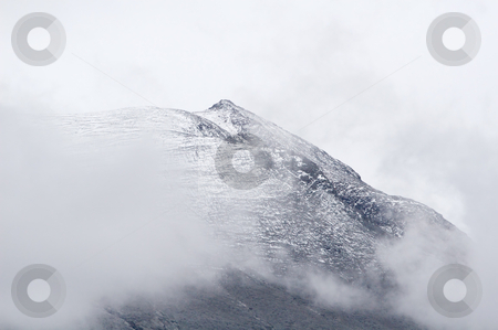 To use this stock image in your creative project, please select the size you need over to the right and click the "Add to Cart" button.
Your downloaded image will come with the Cutcaster watermark removed so don’t worry about the watermark you see on this page. Mountain top stock photo, High mountain top covered partly in first fallen snow. Grey weather. by Anders Peter