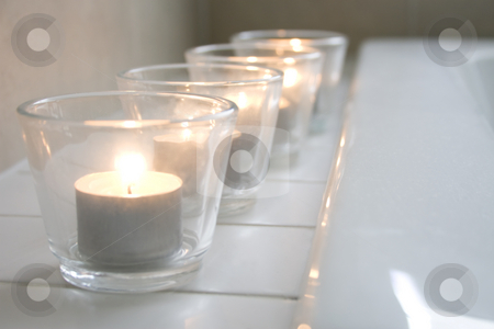 To use this stock image in your creative project, please select the size you need over to the right and click the "Add to Cart" button.
Your downloaded image will come with the Cutcaster watermark removed so don’t worry about the watermark you see on this page. Tealight candles in a row stock photo, Row of tealight candles on the edge of a bathtub by Jodie Johnson