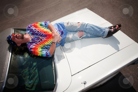 To use this stock image in your creative project, please select the size you need over to the right and click the "Add to Cart" button.
Your downloaded image will come with the Cutcaster watermark removed so don’t worry about the watermark you see on this page. Hippie on a car Hood stock photo, Hippie on the Hood of an old Car by Scott Griessel