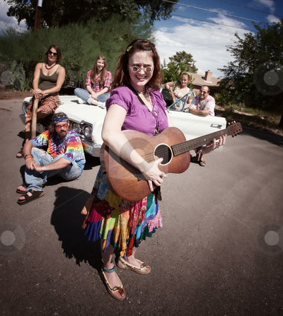 To use this stock image in your creative project, please select the size you need over to the right and click the "Add to Cart" button.
Your downloaded image will come with the Cutcaster watermark removed so don’t worry about the watermark you see on this page. Groovy group with female Singer stock photo, Group of hippies with female guitar player by Scott Griessel