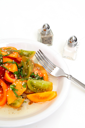 To use this stock image in your creative project, please select the size you need over to the right and click the "Add to Cart" button.
Your downloaded image will come with the Cutcaster watermark removed so don’t worry about the watermark you see on this page. Tomato Salad stock photo, Different types of heirloom tomatoe wedges with thinly sliced basil leaves, sesame seeds and an olive oil and raspberry vinegar dressing by Lynn Bendickson