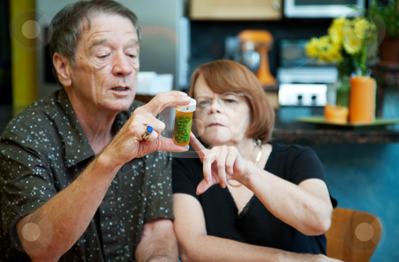 To use this stock image in your creative project, please select the size you need over to the right and click the "Add to Cart" button.
Your downloaded image will come with the Cutcaster watermark removed so don’t worry about the watermark you see on this page. Couple at Home with Medication stock photo, Couple at Home Considering Medication in Bottle by Scott Griessel