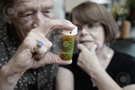 To use this stock image in your creative project, please select the size you need over to the right and click the "Add to Cart" button.
Your downloaded image will come with the Cutcaster watermark removed so don’t worry about the watermark you see on this page. Senior Couple at Home with Perscription stock photo, Senior couple at home with prescription bottle, focus by Scott Griessel