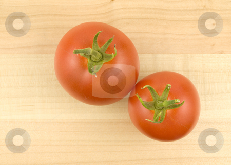 To use this stock image in your creative project, please select the size you need over to the right and click the "Add to Cart" button.
Your downloaded image will come with the Cutcaster watermark removed so don’t worry about the watermark you see on this page. Two Tomatoes on wooden background stock photo, Two ripe tomatoes on a wooden background by John Teeter