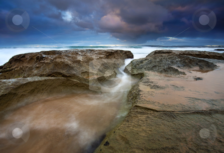 To use this stock image in your creative project, please select the size you need over to the right and click the "Add to Cart" button.
Your downloaded image will come with the Cutcaster watermark removed so don’t worry about the watermark you see on this page. Storm Surge stock photo, A stormy sunrise at Knights Beach has the waves surging through every crack in the limestone. by Mike Dawson