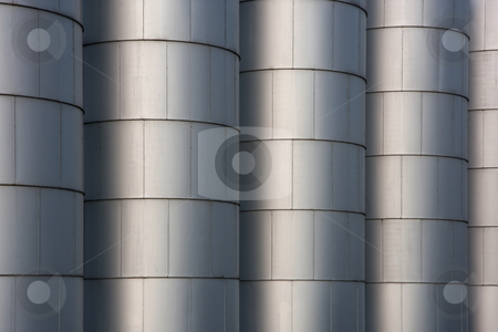 To use this stock image in your creative project, please select the size you need over to the right and click the "Add to Cart" button.
Your downloaded image will come with the Cutcaster watermark removed so don’t worry about the watermark you see on this page. Grain bins - industrial background stock photo, A row of metal round grain storage bins with rivets - industrial background and texture by Marek Uliasz