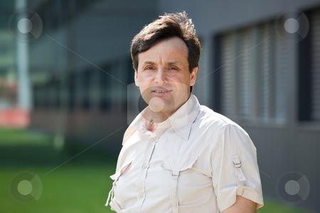To use this stock image in your creative project, please select the size you need over to the right and click the "Add to Cart" button.
Your downloaded image will come with the Cutcaster watermark removed so don’t worry about the watermark you see on this page. Modern middle-aged man stock photo, Portrait of a modern middle-aged man with a building on the background by Natalia Macheda