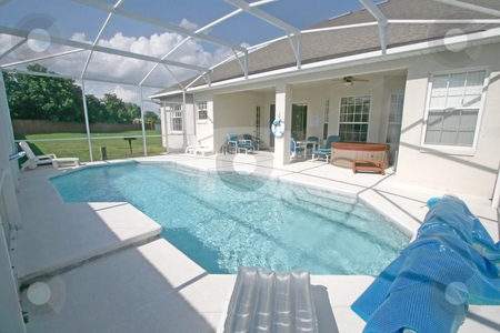To use this stock image in your creative project, please select the size you need over to the right and click the "Add to Cart" button.
Your downloaded image will come with the Cutcaster watermark removed so don’t worry about the watermark you see on this page. Swimming Pool and Lanai stock photo, A Swimming Pool, Hot Tub and Lanai in Florida. by Lucy Clark