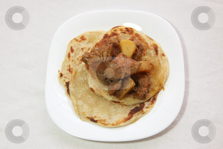 To use this stock image in your creative project, please select the size you need over to the right and click the "Add to Cart" button.
Your downloaded image will come with the Cutcaster watermark removed so don’t worry about the watermark you see on this page. Roti canai prata stock photo, Roti canai prata traditional south indian fried bread, with curry by Kheng Guan Toh