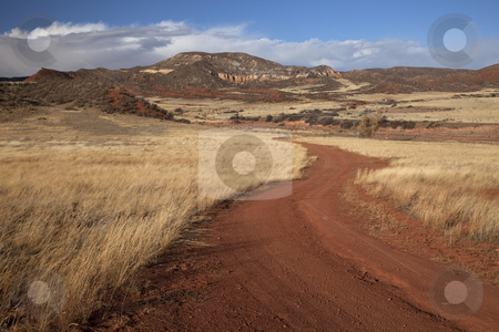 To use this stock image in your creative project, please select the size you need over to the right and click the "Add to Cart" button.
Your downloaded image will come with the Cutcaster watermark removed so don’t worry about the watermark you see on this page. Windy ranch road in mountain valley stock photo, Windy road in Red Mountain Open Space in northern Colorado (Larimer County), fall scenery with dry grass moved by wind by Marek Uliasz