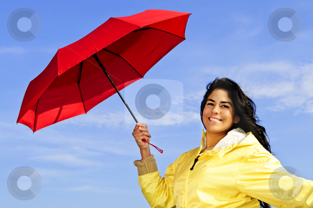 To use this stock image in your creative project, please select the size you need over to the right and click the "Add to Cart" button.
Your downloaded image will come with the Cutcaster watermark removed so don’t worry about the watermark you see on this page. Beautiful young woman in raincoat with umbrella stock photo, Portrait of beautiful girl wearing yellow raincoat holding red umbrella on windy day by Elena Elisseeva
