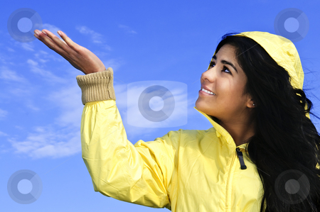 To use this stock image in your creative project, please select the size you need over to the right and click the "Add to Cart" button.
Your downloaded image will come with the Cutcaster watermark removed so don’t worry about the watermark you see on this page. Beautiful young woman in raincoat checking for rain stock photo, Portrait of beautiful smiling girl wearing yellow raincoat looking up checking for rain by Elena Elisseeva