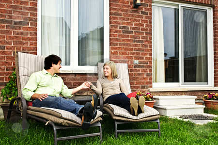 To use this stock image in your creative project, please select the size you need over to the right and click the "Add to Cart" button.
Your downloaded image will come with the Cutcaster watermark removed so don’t worry about the watermark you see on this page. Happy couple relaxing at home stock photo, Happy couple in backyard of new home sitting on lounge chairs by Elena Elisseeva
