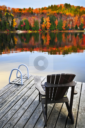 To use this stock image in your creative project, please select the size you need over to the right and click the "Add to Cart" button.
Your downloaded image will come with the Cutcaster watermark removed so don’t worry about the watermark you see on this page. Wooden dock on autumn lake stock photo, Wooden dock with chair on calm fall lake by Elena Elisseeva