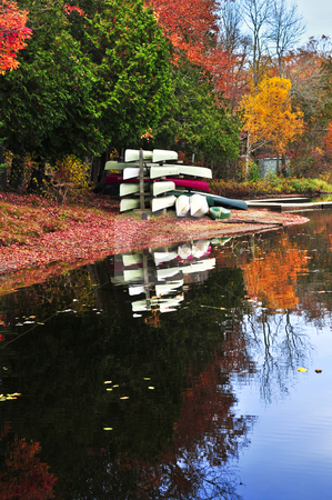 To use this stock image in your creative project, please select the size you need over to the right and click the "Add to Cart" button.
Your downloaded image will come with the Cutcaster watermark removed so don’t worry about the watermark you see on this page. Fall forest reflections with canoes stock photo, Canoes at forest of colorful autumn trees reflecting in calm lake by Elena Elisseeva