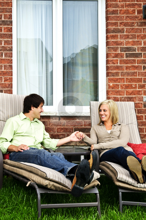 To use this stock image in your creative project, please select the size you need over to the right and click the "Add to Cart" button.
Your downloaded image will come with the Cutcaster watermark removed so don’t worry about the watermark you see on this page. Happy couple relaxing at home stock photo, Happy couple in backyard of new home sitting on lounge chairs by Elena Elisseeva