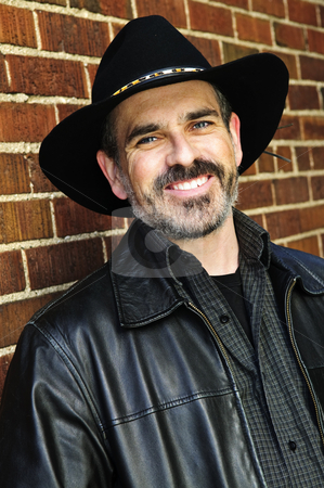To use this stock image in your creative project, please select the size you need over to the right and click the "Add to Cart" button.
Your downloaded image will come with the Cutcaster watermark removed so don’t worry about the watermark you see on this page. Bearded man in cowboy hat stock photo, Man with beard in cowboy hat and leather jacket by Elena Elisseeva