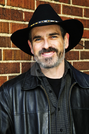 To use this stock image in your creative project, please select the size you need over to the right and click the "Add to Cart" button.
Your downloaded image will come with the Cutcaster watermark removed so don’t worry about the watermark you see on this page. Bearded man in cowboy hat stock photo, Man with beard in cowboy hat and leather jacket by Elena Elisseeva