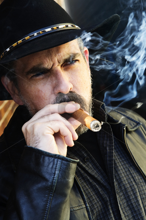 To use this stock image in your creative project, please select the size you need over to the right and click the "Add to Cart" button.
Your downloaded image will come with the Cutcaster watermark removed so don’t worry about the watermark you see on this page. Bearded man smoking cigar stock photo, Man with beard in cowboy hat smoking cigar by Elena Elisseeva