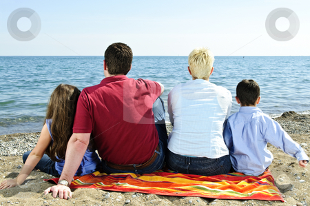 To use this stock image in your creative project, please select the size you need over to the right and click the "Add to Cart" button.
Your downloaded image will come with the Cutcaster watermark removed so don’t worry about the watermark you see on this page. Family sitting at beach stock photo, Family sitting on towel at sandy beach by Elena Elisseeva