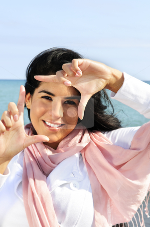 To use this stock image in your creative project, please select the size you need over to the right and click the "Add to Cart" button.
Your downloaded image will come with the Cutcaster watermark removed so don’t worry about the watermark you see on this page. Beautiful young woman framing her face stock photo, Portrait of beautiful smiling brunette girl framing her face at beach by Elena Elisseeva