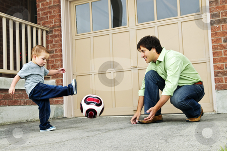To use this stock image in your creative project, please select the size you need over to the right and click the "Add to Cart" button.
Your downloaded image will come with the Cutcaster watermark removed so don’t worry about the watermark you see on this page. Father and son playing soccer stock photo, Father teaching son to play soccer on driveway by Elena Elisseeva