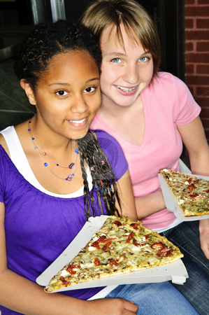 To use this stock image in your creative project, please select the size you need over to the right and click the "Add to Cart" button.
Your downloaded image will come with the Cutcaster watermark removed so don’t worry about the watermark you see on this page. Girls eating pizza stock photo, Two teenage girls sitting and eating pizza by Elena Elisseeva