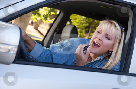 To use this stock image in your creative project, please select the size you need over to the right and click the "Add to Cart" button.
Your downloaded image will come with the Cutcaster watermark removed so don’t worry about the watermark you see on this page. Woman Putting on Lipstick While Driving stock photo, Attractive Woman Putting on Lipstick While Driving. by Andy Dean