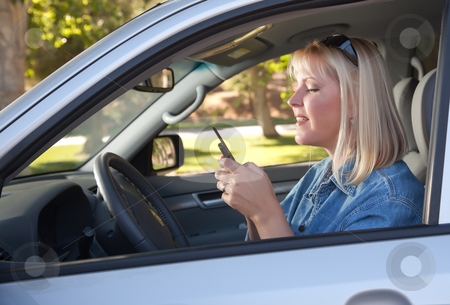 To use this stock image in your creative project, please select the size you need over to the right and click the "Add to Cart" button.
Your downloaded image will come with the Cutcaster watermark removed so don’t worry about the watermark you see on this page. Woman Text Messaging While Driving stock photo, Attractive Blonde Woman Text Messaging on Her Cell Phone While Driving. by Andy Dean