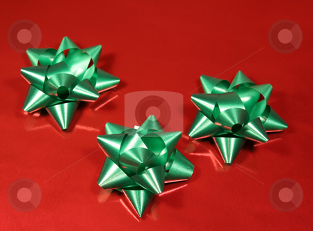 To use this stock image in your creative project, please select the size you need over to the right and click the "Add to Cart" button.
Your downloaded image will come with the Cutcaster watermark removed so don’t worry about the watermark you see on this page. Green Xmas gift bows stock photo, Green Xmas gift bows on red glossy paper. by Chris Hill
