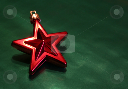 To use this stock image in your creative project, please select the size you need over to the right and click the "Add to Cart" button.
Your downloaded image will come with the Cutcaster watermark removed so don’t worry about the watermark you see on this page. Shiny Red Christmas Star stock photo, A shiny red Christmas star ornament sitting on green wrapping paper. by Chris Hill