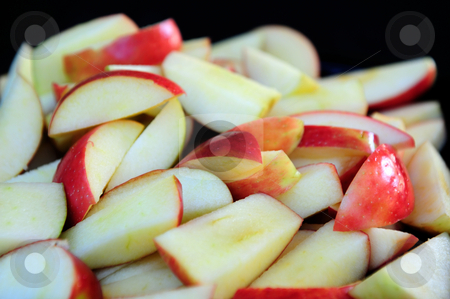 To use this stock image in your creative project, please select the size you need over to the right and click the "Add to Cart" button.
Your downloaded image will come with the Cutcaster watermark removed so don’t worry about the watermark you see on this page. Apple Slices stock photo, Red Apples sliced up into many small pieces with a dark background by Lynn Bendickson