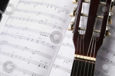 To use this stock image in your creative project, please select the size you need over to the right and click the "Add to Cart" button.
Your downloaded image will come with the Cutcaster watermark removed so don’t worry about the watermark you see on this page. Classic guitar and music chords stock photo, Close up of a classic guitar and musical chords book by Rudyanto Wijaya
