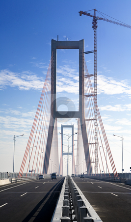 To use this stock image in your creative project, please select the size you need over to the right and click the "Add to Cart" button.
Your downloaded image will come with the Cutcaster watermark removed so don’t worry about the watermark you see on this page. Bridge at finishing construction stage in the morning stock photo, Vertical shot of new bridge in finishing stage. The area still covered by mist at early morning. The new landmark in the city that connecting two island, Suramadu Bridge. ***Stitched image*** by Rudyanto Wijaya