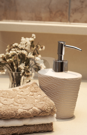 To use this stock image in your creative project, please select the size you need over to the right and click the "Add to Cart" button.
Your downloaded image will come with the Cutcaster watermark removed so don’t worry about the watermark you see on this page. Stack of towels and soap in the bathroom stock photo, Stack of white and brown towels and bottle of liquid soap with some dry flowers in the bathroom by Elena Weber (nee Talberg)