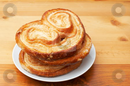 To use this stock image in your creative project, please select the size you need over to the right and click the "Add to Cart" button.
Your downloaded image will come with the Cutcaster watermark removed so don’t worry about the watermark you see on this page. Palmier pastries on white saucer stock photo, Palmier pastries on white saucer, shot on wooden board background by Elena Weber (nee Talberg)
