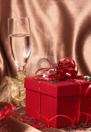 To use this stock image in your creative project, please select the size you need over to the right and click the "Add to Cart" button.
Your downloaded image will come with the Cutcaster watermark removed so don’t worry about the watermark you see on this page. Red gift box with bows and stars stock photo, Party theme - red gift box with bows and stars with a glass of champagne on golden silk background by Elena Weber (nee Talberg)