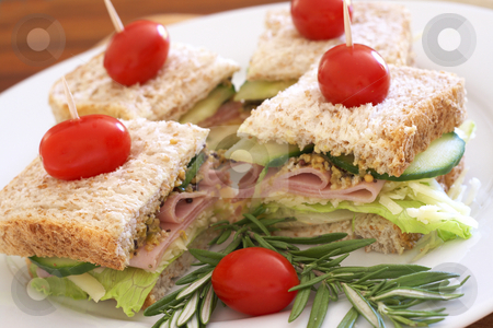 To use this stock image in your creative project, please select the size you need over to the right and click the "Add to Cart" button.
Your downloaded image will come with the Cutcaster watermark removed so don’t worry about the watermark you see on this page. Tasty sandwiches on wholewheat bread stock photo, Tasty club sandwiches with green lettuce, grated cheese, smoked ham and wholegrain mustard on wholewheat bread with rosemary and tomatoes by Elena Weber (nee Talberg)