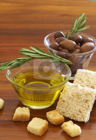To use this stock image in your creative project, please select the size you need over to the right and click the "Add to Cart" button.
Your downloaded image will come with the Cutcaster watermark removed so don’t worry about the watermark you see on this page. Two jars of black olives and olive oil stock photo, Two jars of black olives with stick of rosemary, olive oil, wholewheat bread and croutons on wooden table background by Elena Weber (nee Talberg)