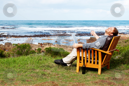 To use this stock image in your creative project, please select the size you need over to the right and click the "Add to Cart" button.
Your downloaded image will come with the Cutcaster watermark removed so don’t worry about the watermark you see on this page. Young man laughing outdoors stock photo, Young businessman laughing at a joke on his laptop. He is sitting outside by the ocean by Elena Weber (nee Talberg)