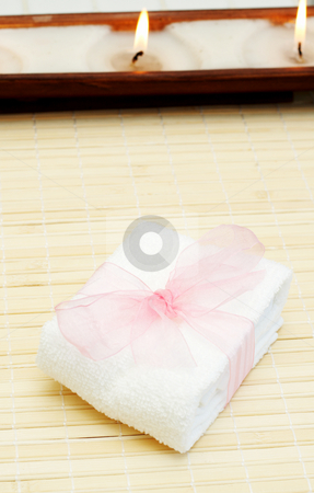 To use this stock image in your creative project, please select the size you need over to the right and click the "Add to Cart" button.
Your downloaded image will come with the Cutcaster watermark removed so don’t worry about the watermark you see on this page. Relaxing spa scene with body products stock photo, Relaxing spa scene with small white towel with pink organza ribbon around it and candles in the background by Elena Weber (nee Talberg)