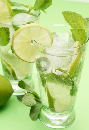 To use this stock image in your creative project, please select the size you need over to the right and click the "Add to Cart" button.
Your downloaded image will come with the Cutcaster watermark removed so don’t worry about the watermark you see on this page. Two mojito cocktails on green background stock photo, Two mojito cocktails with lime, mint leaves and ice on green background by Elena Weber (nee Talberg)