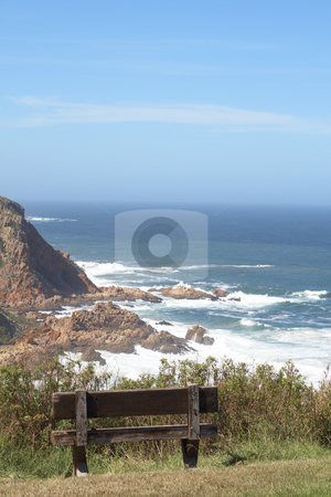 To use this stock image in your creative project, please select the size you need over to the right and click the "Add to Cart" button.
Your downloaded image will come with the Cutcaster watermark removed so don’t worry about the watermark you see on this page. Ocean landscape stock photo, Ocean landscape with mountains and an empty wooden bench on a beautiful summer day by Elena Weber (nee Talberg)