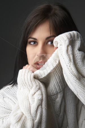 To use this stock image in your creative project, please select the size you need over to the right and click the "Add to Cart" button.
Your downloaded image will come with the Cutcaster watermark removed so don’t worry about the watermark you see on this page. Portrait of beautiful brunette woman stock photo, Portrait of a beautiful young brunette woman wearing a white oversized jersey on black background by Elena Weber (nee Talberg)
