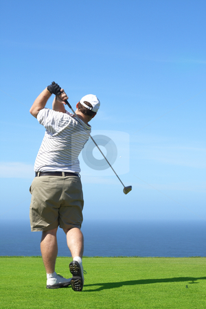 To use this stock image in your creative project, please select the size you need over to the right and click the "Add to Cart" button.
Your downloaded image will come with the Cutcaster watermark removed so don’t worry about the watermark you see on this page. Golfer on the tee box stock photo, Young male golfer hitting the ball from the tee box next to the ocean on a beautiful summer day by Elena Weber (nee Talberg)