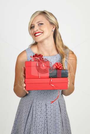To use this stock image in your creative project, please select the size you need over to the right and click the "Add to Cart" button.
Your downloaded image will come with the Cutcaster watermark removed so don’t worry about the watermark you see on this page. Portrait of beautiful blonde woman stock photo, Portrait of a beautiful blonde woman with light blue eyes and evening make-up holding gift boxes on grey background by Elena Weber (nee Talberg)